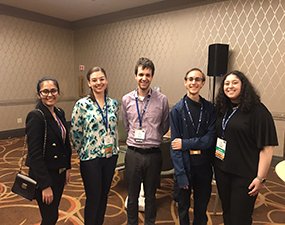 group of people posing in a conference room