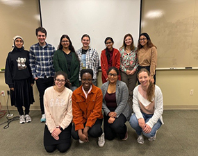 group of people posing in a conference room