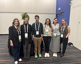 group of people at ECS conference with conference lanyards
