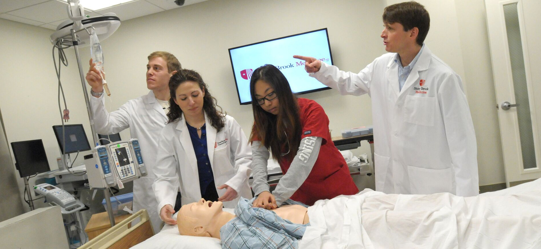 students and instructor in sim center