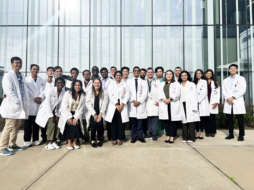 a group image of medical residents outside a building