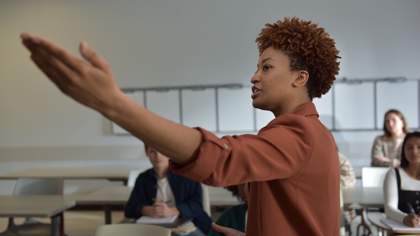 teacher pointing at board (decorative image)
