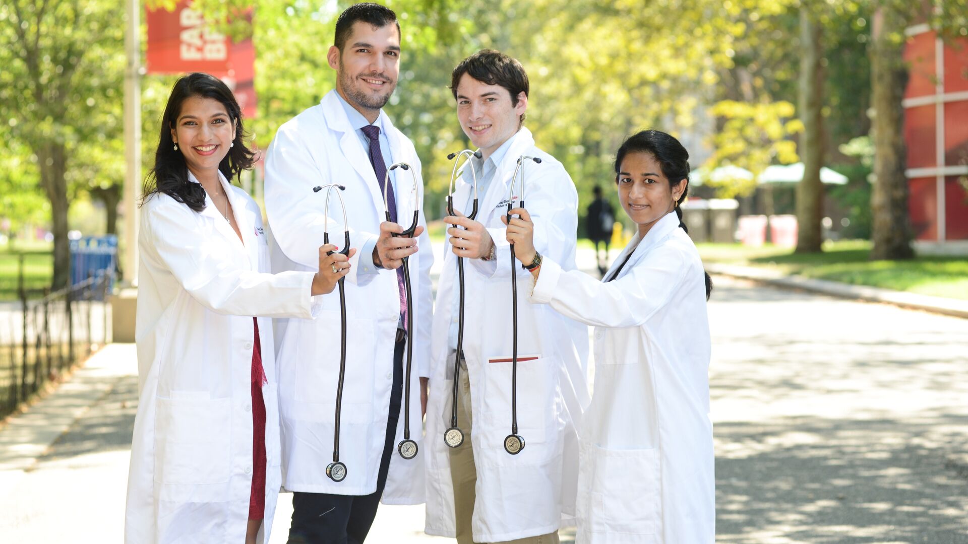 Image of students in white coat with stethoscopes (decorative).