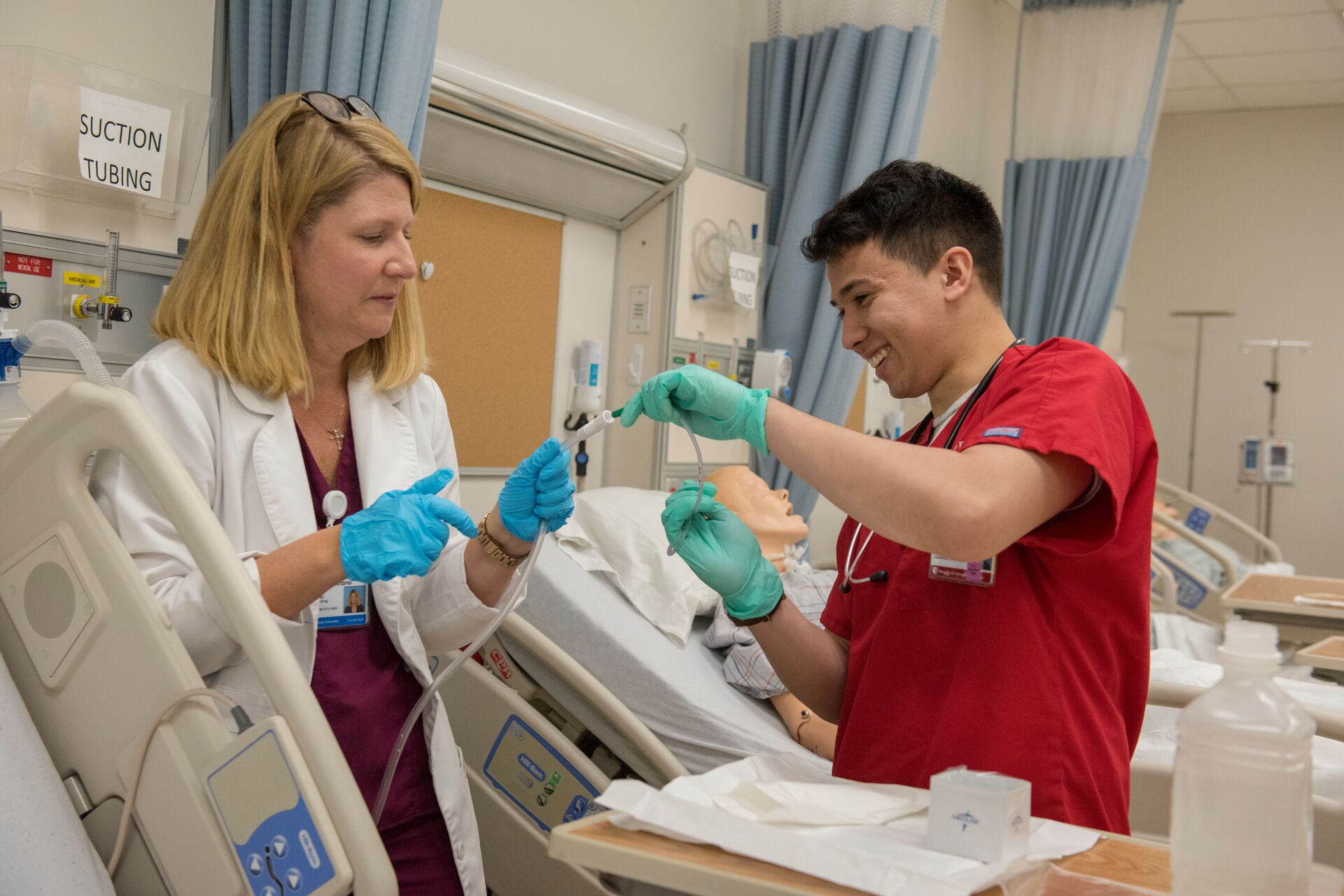 student practicing intubation with teacher guidance