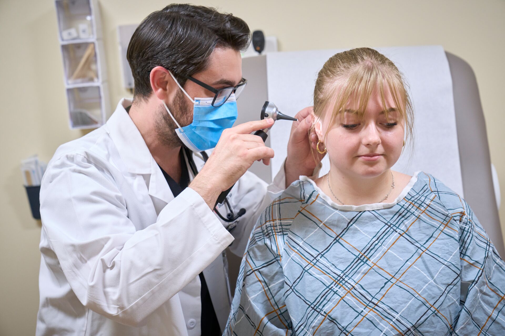 students looking into patient's ear