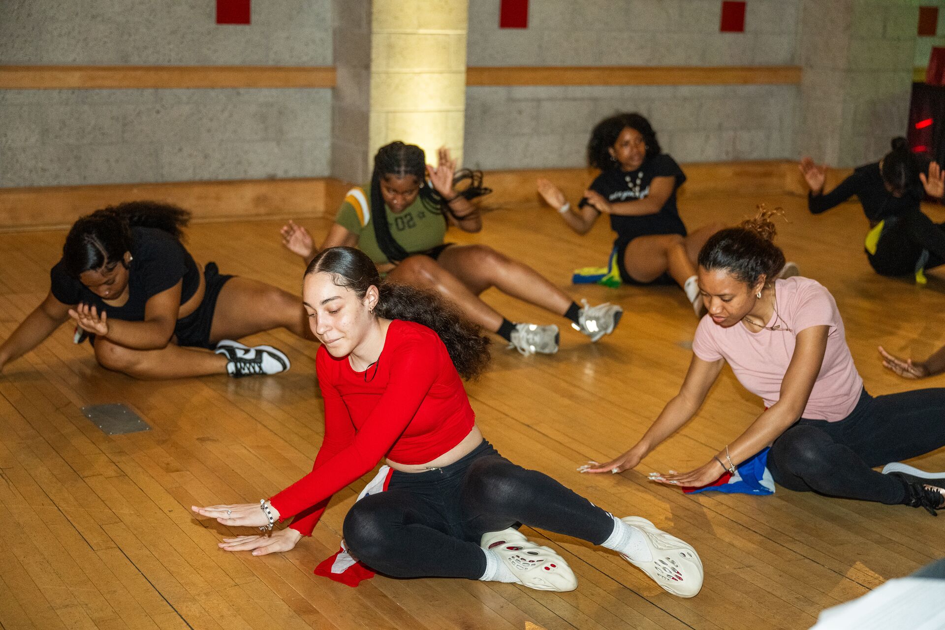Students on the floor doing yoga together.