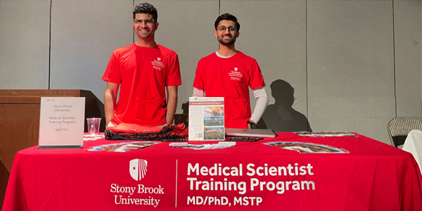 Students at table presenting information about the MSTP program
